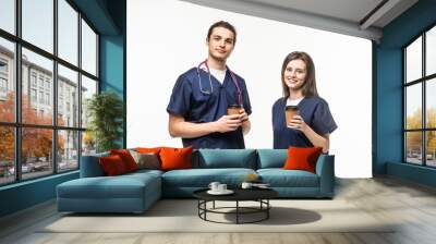 two medics drink coffee isolated on white background Wall mural